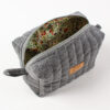 Otwarta lniana kosmetyczka box z szarym zewnętrzem i kolorową kwiatową podszewką