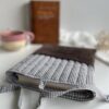 Etui na książkę z materiału w kratkę i miękką kieszenią, minimalistyczny design dla miłośników książek